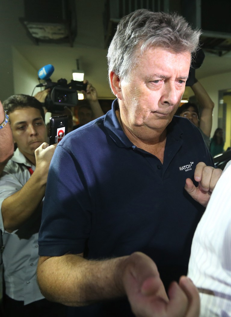 FILE - In this July 7, 2014, file photo, Ray Whelan, a longstanding director and project manager within the MATCH group, arrives at a police station after been arrested, in Rio de Janeiro, Brazil.  Whelan, a top figure in an alleged illegal World Cup ticket-scalping scheme surrendered to Brazilian officials Monday July 14, 2014, four days after police labeled him a fugitive, his lawyer said. (AP Photo/Str, file)