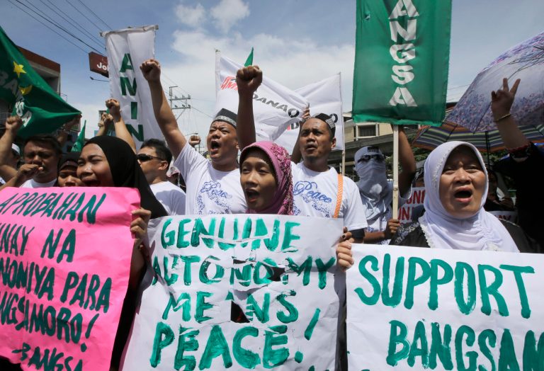 Filipino Muslims shout slogans during a rally near the Presidential Palace in support of the Bangsamoro Basic Law draft that was formally submitted by Philippine President Benigno Aquino III to both houses of Congress Wednesday, Sept. 10, 2014 in Manila, Philippines. Aquino submitted the draft law to Congress that aims to execute a bold plan: End a four-decade rebellion by Muslims in the south by granting them an autonomous region that will have its own government and police force. (AP Photo/Bullit Marquez)