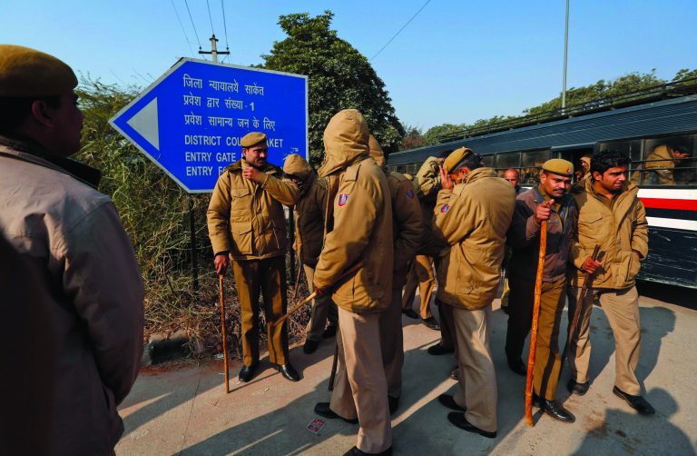 Policemen report for duty at a district court, where the accused in a gang rape are to be produced for trial, in New Delhi, India, Thursday, Jan. 10, 2013. Police have badly beaten the five suspects in the brutal rape and killing of the young woman on a New Delhi bus, the lawyer for three of the men said Thursday, accusing authorities of tampering with evidence in the case that has transfixed India. (AP Photo/Saurabh Das)