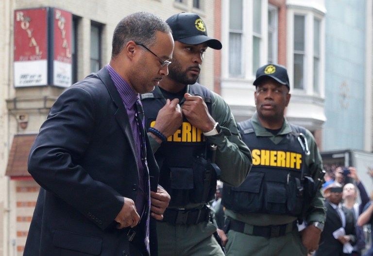 Officer Caesar Goodson, left, one of six Baltimore city police officers charged in connection to the death of Freddie Gray, arrives at a courthouse before receiving a verdict in his trial in Baltimore, Thursday, June 23, 2016. (AP Photo/Patrick Semansky)