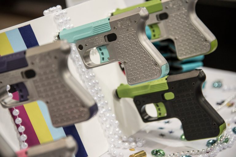 FILE - In this April 30, 2016, file photo, an array of firearms are on display at the annual meeting of the United States Concealed Carry Association in Atlanta, Georgia. Gun rights advocates entered the Trump era with high hopes. After years of frustration they thought a gun-friendly president and Congress would advance their agenda. (AP Photo/Lisa Marie Pane, File)