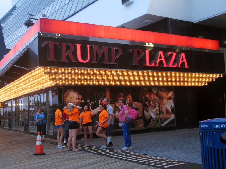 This July 24, 2014 photo shows several lights burned out in the illuminated facade of the Trump Plaza Hotel Casino in Atlantic City, N.J. On Tuesday Aug. 5, 2014, Donald Trump sued Trump Entertainment Resorts, seeking to force the company to remove his name from its two Atlantic City casinos, Trump Plaza and the Trump Taj Mahal, alleging the company had allowed the casinos to fall into disrepair and tarnish the real estate mogul's personal brand. (AP Photo/Wayne Parry)