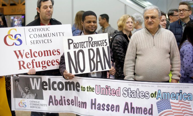 Refugee supporters look on after Abdisellam Hassen Ahmed, a Somali refugee who had been stuck in limbo after President Donald Trump temporarily banned refugee entries, arrival at Salt Lake International Airport, Friday, Feb. 10, 2017, in Salt Lake City. Ahmed meet his daughter for the first time. (AP Photo/Rick Bowmer)
