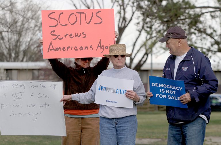 People protest the Supreme Court's McCutcheon decision on Wednesday at John Dam Plaza in Richland, Wash. (AP Photo/The Tri-City Herald, Sarah Gordon)
