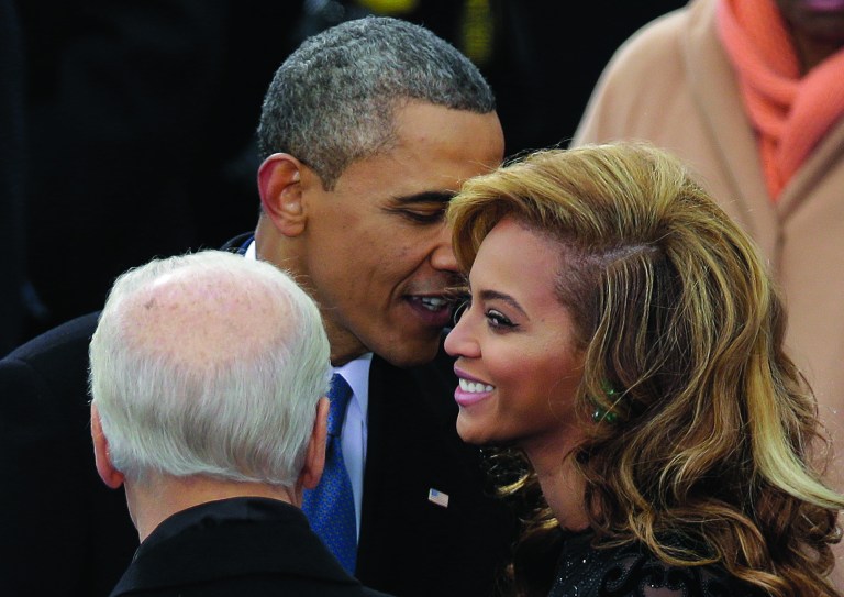 President Barack Obama talks to Beyonce before she sings the National Anthem at his ceremonial swearing-in at the U.S. Capitol during the 57th Presidential Inauguration in Washington, Monday, Jan. 21, 2013. (AP Photo/Evan Vucci)