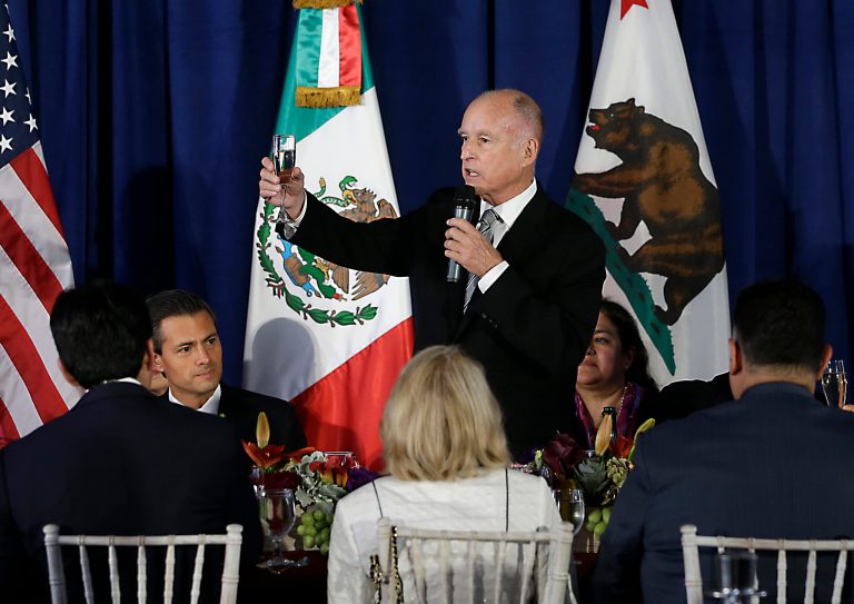 FILE - In this Aug. 26, 2014, file photo, California Gov. Jerry Brown, standing, makes a toast to Mexican President Enrique Pena Nieto, second from left, during a luncheon at the Leland Stanford Mansion in Sacramento, Calif. City council and school board members gathering for dinners, parties or other social affairs must guard their words or notify the public beforehand if a majority will attend and talk policy. The same rules do not apply for state lawmakers, who have long exempted themselves from the transparency rules that apply to other elected bodies in California. The vagueness of the special open meetings law for the state Legislature was highlighted last week when Brown invited all 120 lawmakers to the luncheon honoring Nieto. (AP Photo/Rich Pedroncelli, File)