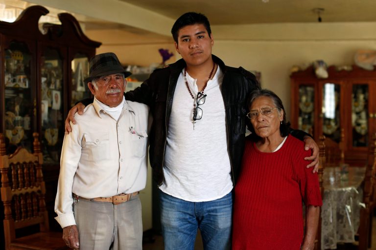 In this Friday, Oct. 3, 2014 photo, Dario Guerrero, center, poses for a portrait with his grandparents Dario Guerrero Garrido and Crescencia Garcia Vazquez at their home in the outskirts of Mexico City. Guerrero, a Harvard University junior, accompanied his dying mother to Mexico without government permission, and is now unable to return to the United States. (AP Photo/Dario Lopez-Mills)