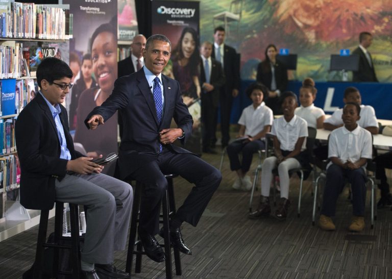 President Barack Obama, right, with student moderator Osman Yaya, left, responds to a question during a 'Virtual Field Trip' with middle school students from around the country at Anacostia Library April 30, 2015 in Washington, D.C. (Photo by Pool/Getty Images)