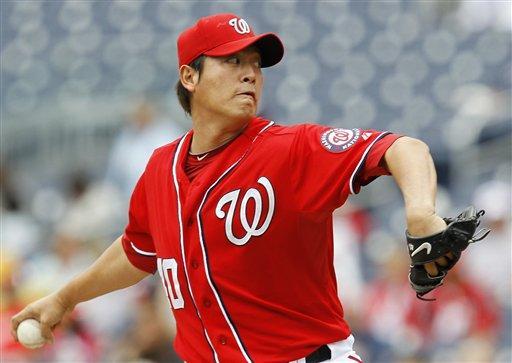 Washington Nationals starting pitcher Chien-Ming Wang, of Taiwan, delivers the ball to the Florida Marlins during the first inning of a baseball game, Sunday, Sept. 18, 2011, in Washington. (AP Photo/Luis M. Alvarez)