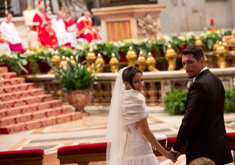 Sara Pisano, left, and Danilo Spagnoli, just married by Pope Francis, smile during the wedding ceremony  in St. Peter's Basilica at the Vatican, Sunday, Sept. 14, 2014.  Pope Francis married 20 couples Sunday, including some who already live together and those with children, technically a sin in the eyes of the church. (AP Photo/Alessandra Tarantino)