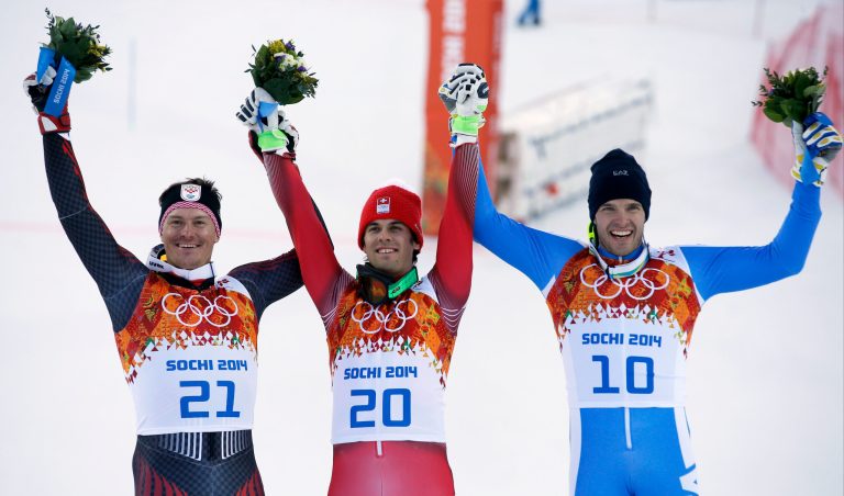 Men's supercombined medalists from left, Croatia's Ivica Kostelic (silver), Switzerland's Sandro Viletta (gold) and Italy's Christof Innerhofer (bronze) pose for photographers on the podium during a flower ceremony at the Alpine ski venue at the Sochi 2014 Winter Olympics, Friday, Feb. 14, 2014, in Krasnaya Polyana, Russia.(AP Photo/Christophe Ena)