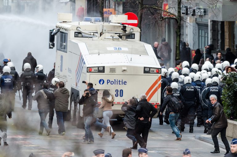 Police use a water canon as right wing demonstrators protest at a memorial site at the Place de la Bourse in Brussels, Sunday. (AP Photo/Geert Vanden Wijngaert)