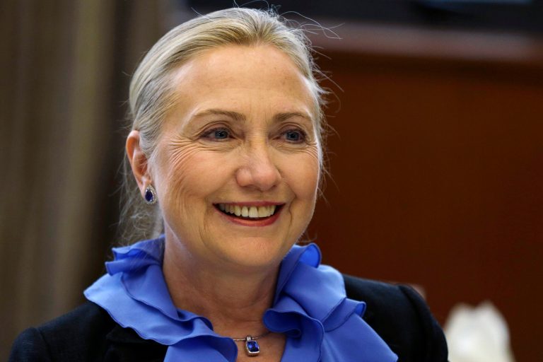   FILE - In this Nov. 16, 2012, file photo, U.S. Secretary of State Hillary Rodham Clinton poses for photographs before a dinner hosted by Singapore's Minister for Foreign Affairs and Law K. Shanmugam, unseen, at Ministry of Foreign Affairs in Singapore. The State Department says Saturday, Dec. 15, 2012, that Clinton, who skipped an overseas trip this past week because of a stomach virus, sustained a concussion after fainting. Sheâs now recovering at home and being monitored by doctors. An aide, Philippe Reines, says in a statement that Clinton will continue to work from home next week, as the recommendation of her doctors. (AP Photo/Matt Rourke, File)  
