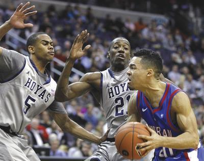 Luis M. Alvarez/AP
Markel Starks(5), Jason Clark(21)and Georgetown led by six at halftime before pulling away from Blake Jolivette and American.