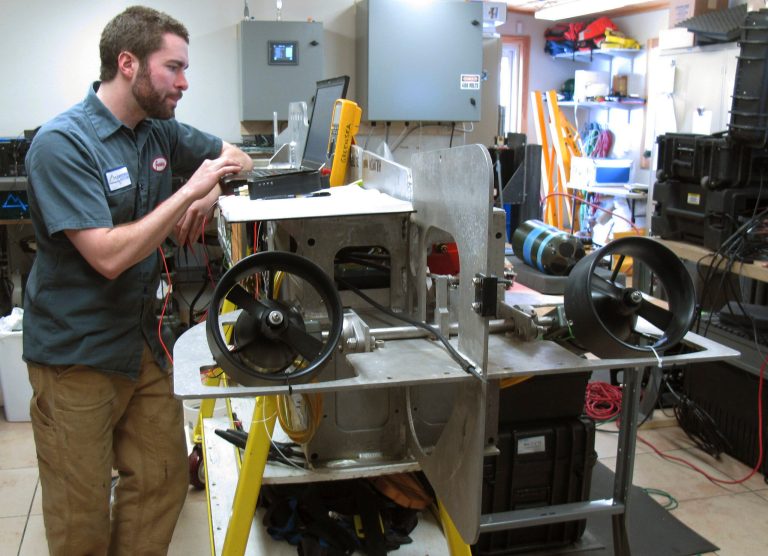 In this April 16, 2014 photo, engineer Jeremy Larson works on a remote operated underwater vehicle in the shop of Greensea Systems in Richmond, Vt. Greensea develops underwater navigation products far from salt water, and the company highlights how Vermont high-tech companies are doing unusual work with word-wide reach. Larson, a University of Vermont physics graduate, said his job allows him to work in robotics and stay in Vermont. (AP Photo/Wilson Ring)