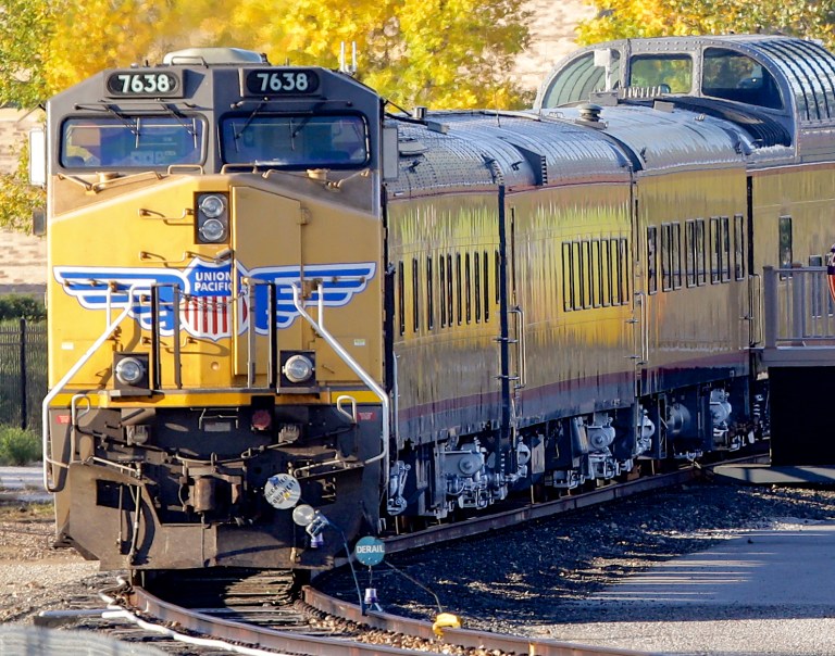 FILE - In this Thursday, Oct. 17, 2013, file photo, a Union Pacific locomotive with passenger cars in tow is parked in Omaha, Neb. Union Pacific is reporting a 13 percent jump in fourth-quarter profit as strong grain, automotive and industrial shipments offset a 10 percent drop in loads of coal, the company reported Thursday, Jan. 23, 2014. (AP Photo/Nati Harnik, File)