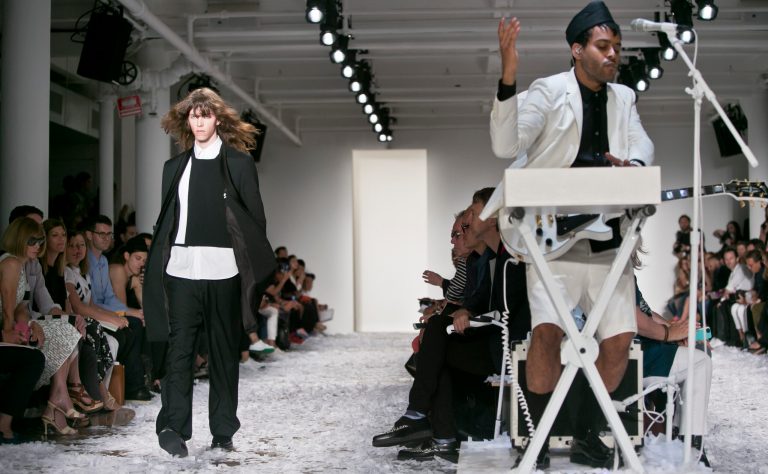 U.S. musician George Lewis Jr., aka Twin Shadow, performs as fashion from Public School Spring 2015 collection is modeled during Fashion Week on Sunday, Sept. 7, 2014 in New York.  (AP Photo/Bebeto Matthews)