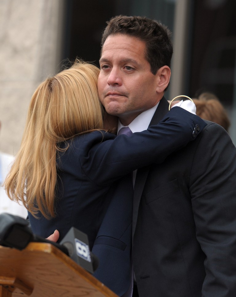 Former Rock Island County Sheriff Jeffrey Boyd hugs his wife Ann Boyd after he resigned from office Thursday Sept. 11, 2014 after he entered an Alford plea, a plea that allows him to assert his innocence while admitting the evidence the prosecution would present would likely to persuade a judge or jury to find him guilty, to attempted official misconduct based on attempted cyberstalking, according to Illlinois Attorney General Lisa Madigan.  (AP Photo/The Dispatch, Todd Welvaert)