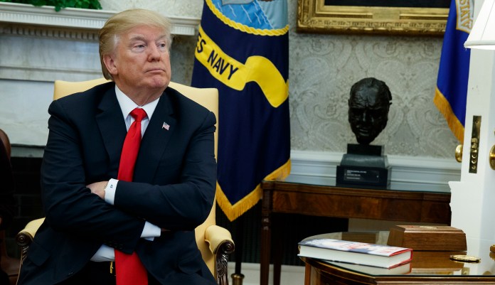A New York Times columnist said the indictments showed that "President Trump is either totally compromised by the Russians or is a towering fool, or both." (AP Photo/Evan Vucci)