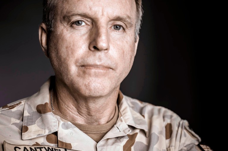   In this undated photo provided by Maj. Gen. John Cantwell, the general poses for a formal portrait. The troops Cantwell was fighting alongside in the Gulf War had used bulldozing tanks to bury the man alive. This hand - so jarringly human amid the cold mechanics of bombs and anonymous enemies - was about to wedge itself, the Australian man would write decades later, 