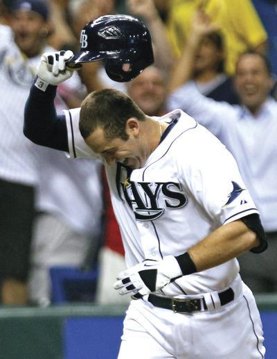 Tampa Bay Rays'Evan Longoria tips his helmet after hitting a 12th inning walk off home run off New York Yankees relief pitcher Scott Proctor during a baseball game Thursday, Sept. 29, 2011, in St. Petersburg, Fla.(AP Photo/Chris O'Meara)
