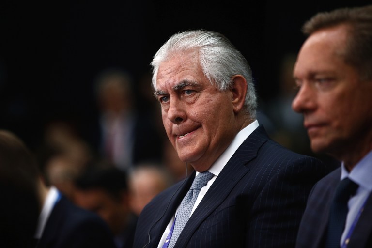 Rex Tillerson, chief executive officer of Exxon Mobil Corp., left, listens on the opening day of the St. Petersburg International Economic Forum 2016in Saint Petersburg, Russia, on Thursday, June 16, 2016. Tillerson, now Donald Trump's pick for secretary of state, endorsed a carbon tax to discourage greenhouse-gas emissions and mitigate climate change. (Simon Dawson/Bloomberg)