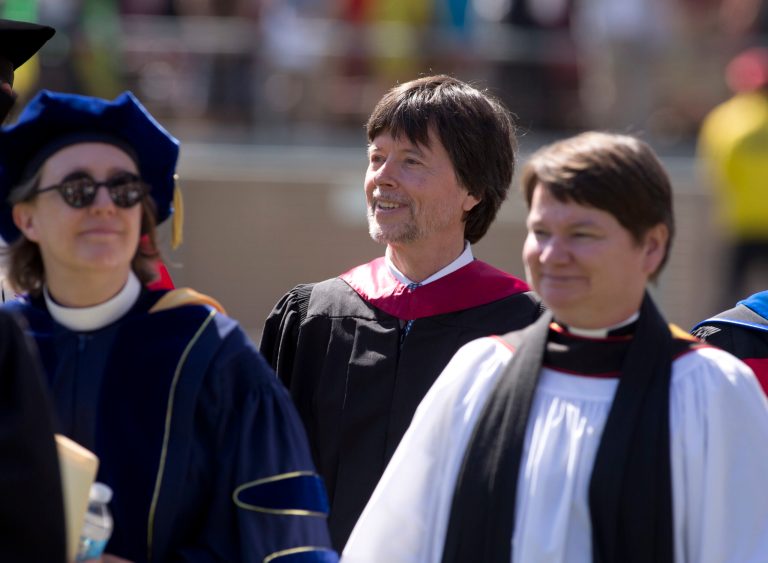 Documentary filmmaker Ken Burns, center, arrives to deliver the commencement address at Stanford University graduation exercises, Sunday, June 12, 2016, at Stanford Stadium in Stanford, Calif. (AP Photo/D. Ross Cameron)