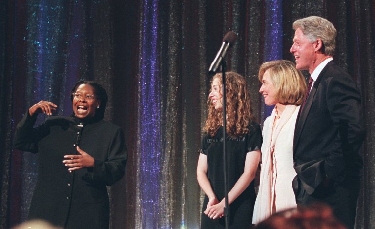 Whoopi Goldberg, left, presides over the ceremonies as President Clinton is joined on stage by daughter Chelsea, third from right, and first lady Hillary Rodham Clinton during a celebration of Clinton's 50th birthday at New York's Radio City Music Hall Sunday Aug. 18, 1996. Last week she slapped the media for being aggressive with Hillary Clinton. (AP Photo/Greg Gibson)