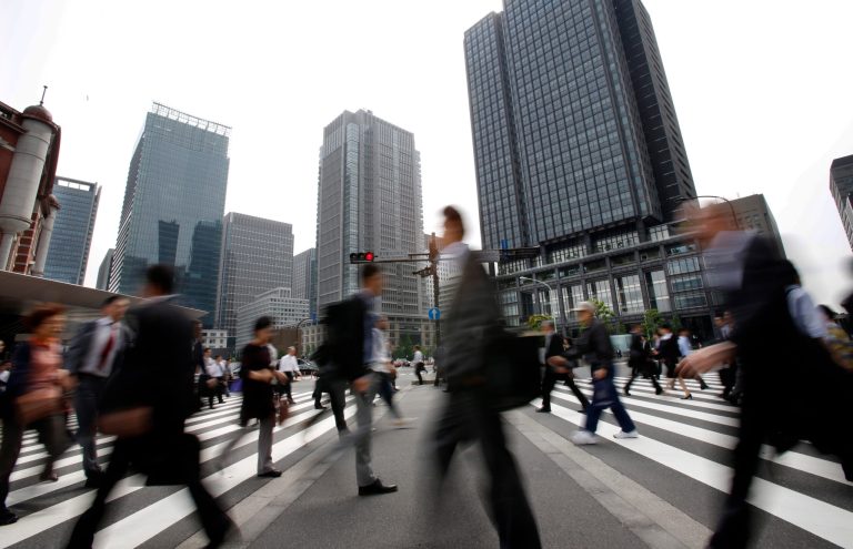 In this Wednesday, May 14, 2014 photo, people walk along a pedestrian crossing in Tokyo. Preliminary data show Japan's economy grew at a 5.9 percent annualized rate in the January-March quarter as companies and consumers stepped up buying ahead of an increase in the sales tax. The growth figures for the world's third-largest economy released Thursday, May 15 were in line with expectations a pre-tax hike rush. (AP Photo/Shizuo Kambayashi)