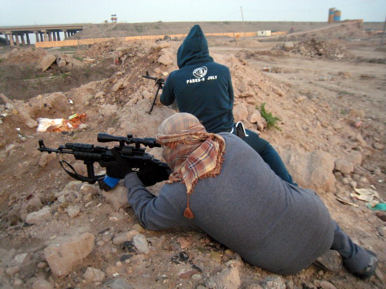 In this Thursday, Jan. 23, 2014 photo, gunmen take up combat positions in Fallujah, Iraq. Islamic militants controlling a mainly Sunni area west of Baghdad are so well-armed that they could occupy the capital, members of Iraq's al-Qaida branch - known as the Islamic State of Iraq and the Levant - have taken over parts of Ramadi, the capital of the largely Sunni western province of Anbar. (AP Photo)