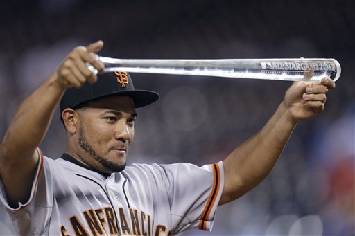 National League's Melky Cabrera, of the San Francisco Giants, shows off his MVP trophy after the MLB All-Star baseball game Tuesday, July 10, 2012, in Kansas City, Mo. The National League won 8-0. (AP Photo/Jeff Roberson)