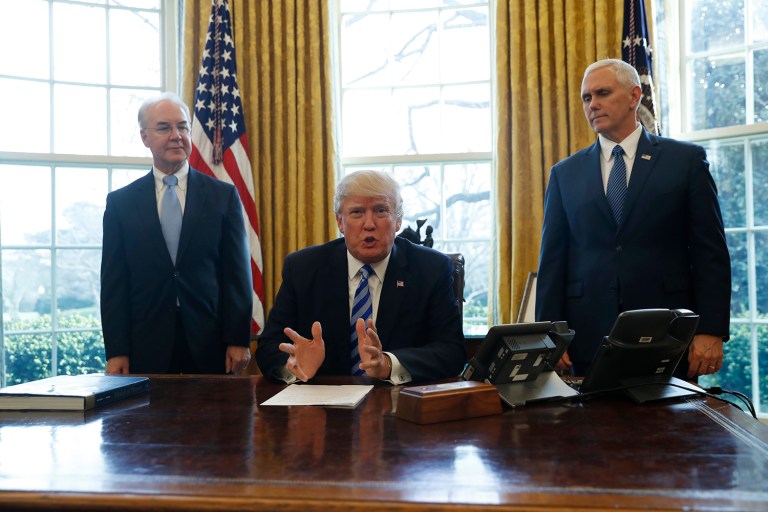 President Donald Trump, flanked by Health and Human Services Secretary Tom Price, left, and Vice President Mike Pence, meets with members of the media regarding the health care overhaul bill, Friday, March 24, 2017, in the Oval Office of the White House in Washington. (AP Photo/Pablo Martinez Monsivais)