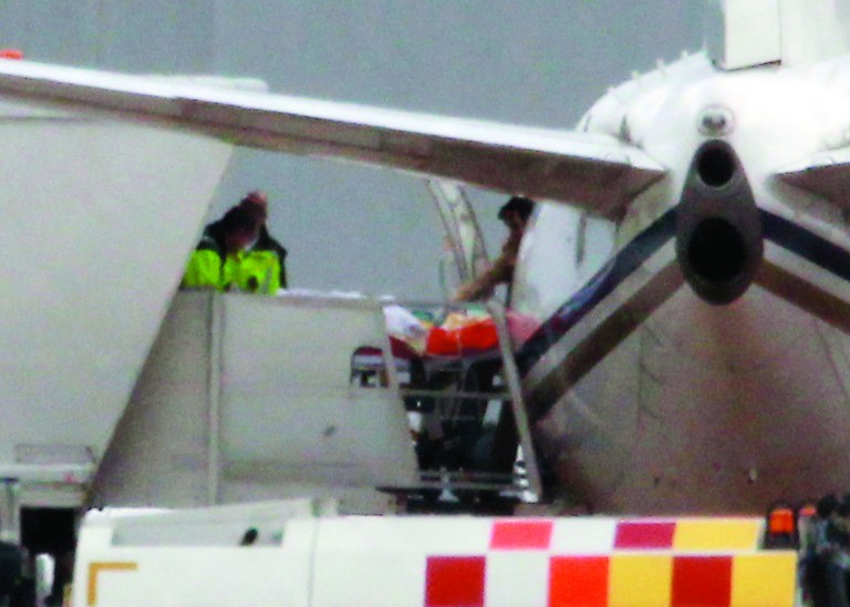 Malala Yousufzai, 14, the Pakistani schoolgirl shot in the head by Taliban gunmen, is transferred from the plane aboard a stretcher as she arrives at Birmingham Airport, England, Monday October 15, 2012. Malala Yousufzai, will receive medical care by doctors and nurses who are specialists in helping British soldiers wounded in Afghanistan and Iraq, after she was shot on a bus in front of her friends for promoting girls' education and criticizing militants. (AP Photo/David Jones, PA) UNITED KINGDOM OUT - NO SALES - NO ARCHIVES