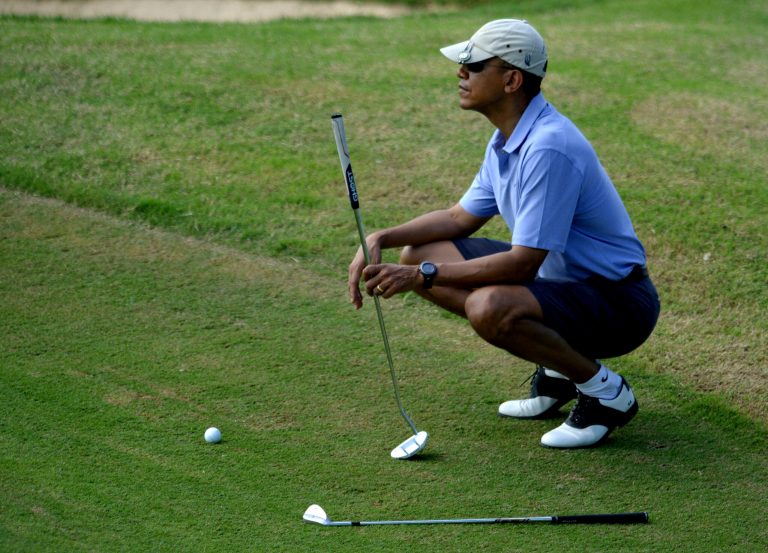 President Obama lines up his shot on the 9th green during a round of golf at Mid Pacific Country Club on December 23, 2013 in Kailua, Hawaii. (Photo by Cory Lum-Pool/Getty Images)