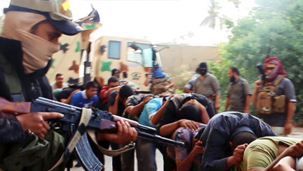 This image posted on a militant website June 14, 2014, which has been verified appears to show militants from the al-Qaeda-inspired Islamic State of Iraq and Syria (ISIS) leading away captured Iraqi soldiers dressed in plain clothes after taking over a base in Tikrit, Iraq. AP Photo