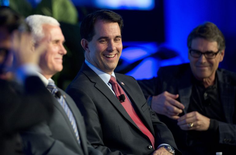 This Nov. 19, 2014 file photo, possible Republican presidential candidates Wisconsin Gov. Scott Walker, center, Indiana Gov. Mike Pence, left, and Texas Gov. Rick Perry, right, speak at the Republican Governors Association annual conference in Boca Raton, Fla. (AP Photo/J Pat Carter, File)