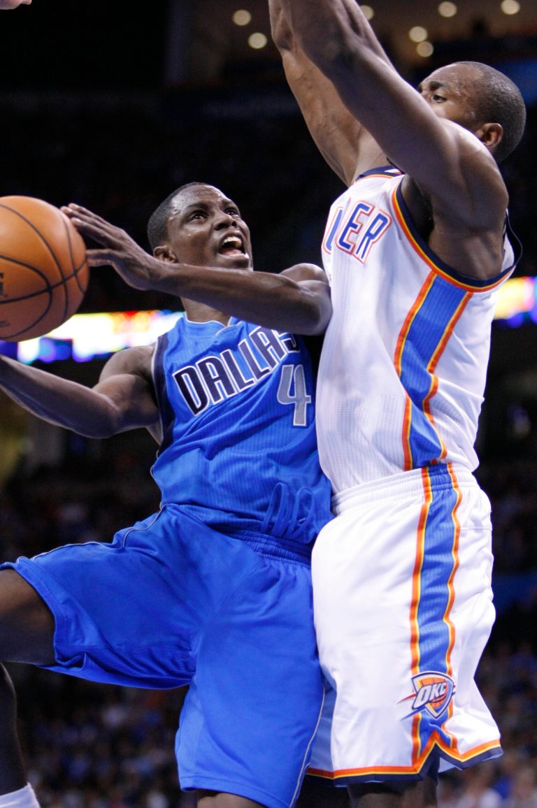  Dallas Mavericks guard Darren Collison, left, goes to the basket in front of Oklahoma City Thunder forward Serge Ibaka, right, during the first quarter of an NBA basketball game in Oklahoma City, Thursday, Dec. 27, 2012. (AP Photo/Alonzo Adams)  
