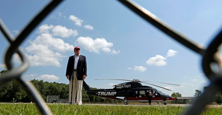 Republican presidential candidate Donald Trump talks to the media after arriving by helicopter at a nearby ballpark before Trump attended the Iowa State Fair Saturday, Aug. 15, 2015, in Des Moines. (AP Photo/Charlie Riedel)