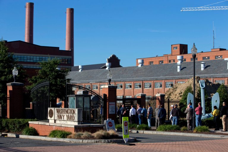 In this Sept. 18 file photo, employees of the Washington Navy Yard line up to enter through a gate two days after a gunman killed twelve people and was killed himself inside.ÃÂ Senators expressed frustration Thursday with the process used to grant security clearances to federal workers following the Edward Snowden leaks and Aaron Alexis' killing rampage at the Navy Yard.ÃÂ (AP Photo/Jacquelyn Martin, File)