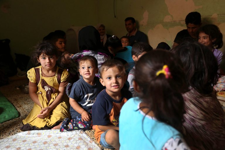 Internally displaced Iraqi Yazidis who fled from Sinjar and other towns after advances by Islamic militants take shelter at a school in Dahuk, 260 miles (420 kilometers) northwest of Baghdad, Thursday, Oct. 2, 2014. The Yazidis now living in the Kurdish city of Dahuk are cautiously optimistic - wary after having already lost so much, but hopeful to return home and pick up the pieces, as the Kurdish military says it is now on a push toward Sinjar, located in the deserts of northwestern Iraq near the Syrian border, in an assault aimed at retaking the town from the extremists. (AP Photo/Hadi Mizban)