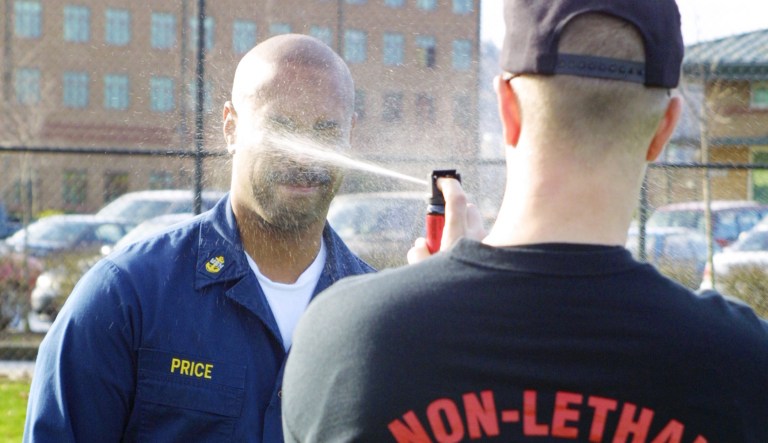 Master-at-Arms 1st Class Austin DeMary, an Anti-Terrorism Force Protection Instructor, gives Chief Gunner's Mate Chris Price a shot of pepper spray in this Feb. 26, 2004, file photo. (RELEASED)