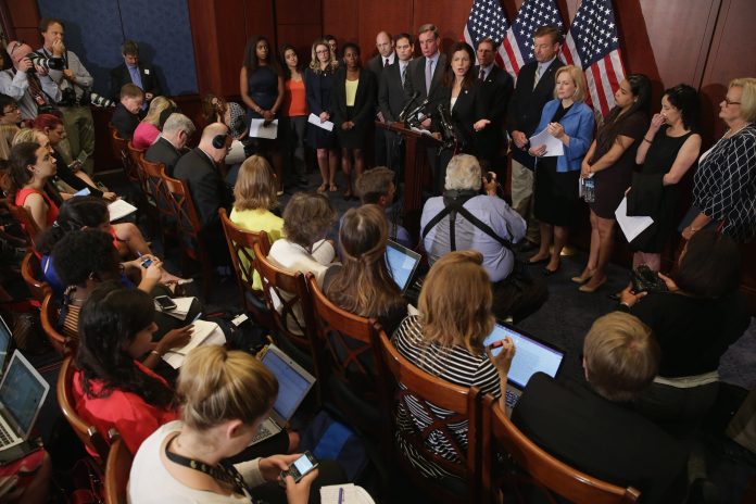 Sen. Claire McCaskill, D-Mo., Sen. Dean Heller, R-N.V., Sen. Richard Blumenthal, D-Conn., Sen. Kirsten Gillibrand, D-N.Y., Sen. Kelly Ayotte, R-N.H., Sen. Mark Warner, D-Va. and Sen. Marco Rubio, R-Fla., are joined by sexual assault survivors during a news conference about new legislation aimed at curbing sexual assaults on college and university campuses at the U.S. Capitol Visitors Center July 30, 2014 in Washington, D.C. (Photo by Chip Somodevilla/Getty Images)