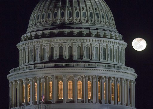 The moon rises behind the U.S. Capitol Dome in Washington as Congress works into the late evening, Sunday, Dec. 30, 2012 to resolve the stalemate over the pending 