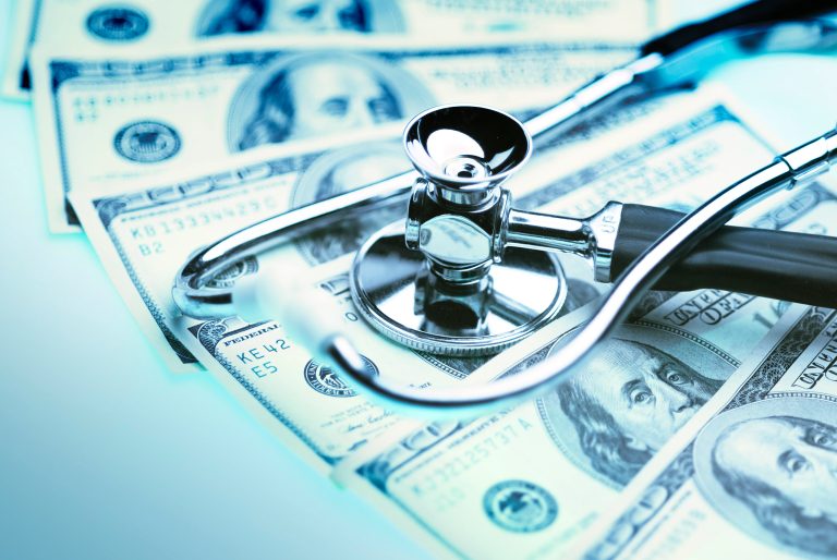 State health officials awarded $56 million to a dozen hospitals and nursing homes even as the governor repeated dire warnings Monday that some Brooklyn hospitals will close without more federal help.