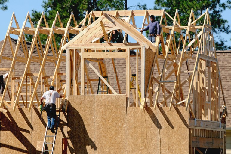 In this Oct. 6, 2014 photo, construction crews work on a home in the Brunswick Forest neighborhood in Leland, N.C. The National Association of Home Builders/Wells Fargo releases its monthly index of builder sentiment on Thursday, Oct. 16, 2014. (AP Photo/The Star-News, Mike Spencer) LOCAL TELEVISION OUT; LOCAL INTERNET OUT