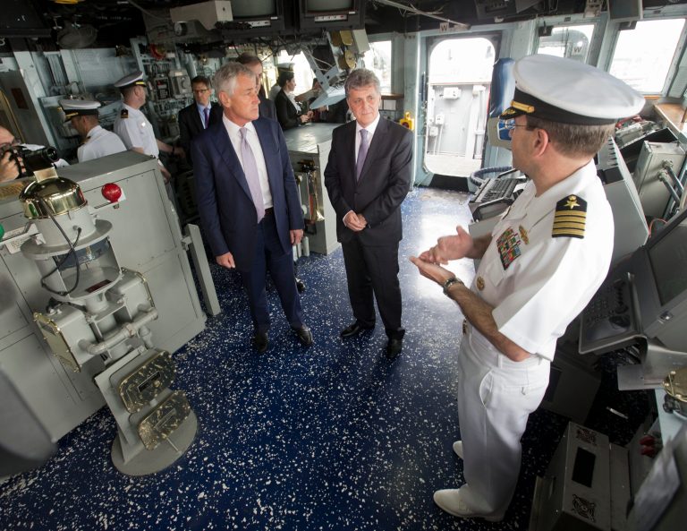 U.S. Defense Secretary Chuck Hagel, left, Romanian Defense Minister Mircea Dusa, center, and Commanding Officer Robert Katz, right, during their tour of the bridge of the USS Vella Gulf, in Constanta, Romania, Thursday, June 5, 2014. (AP Photo/Pablo Martinez Monsivais, Pool)