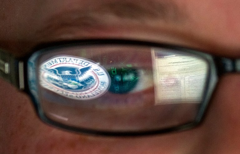 This Sept. 30, 2011, file photo shows a reflection of the Department of Homeland Security logo in the eyeglasses of a cybersecurity analyst at Homeland Security's secretive cyber defense facility in Idaho Falls, Idaho. (AP Photo)Â 