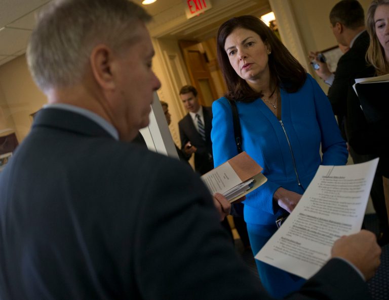 Sen. Kelly Ayotte, R-NH., right, talks with Sen. Lindsey Graham, S.C., before their joint news conference on unemployment and military pension cuts, Wednesday, Jan. 8, 2014, on Capitol Hill in Washington. (AP Photo/Pablo Martinez Monsivais)