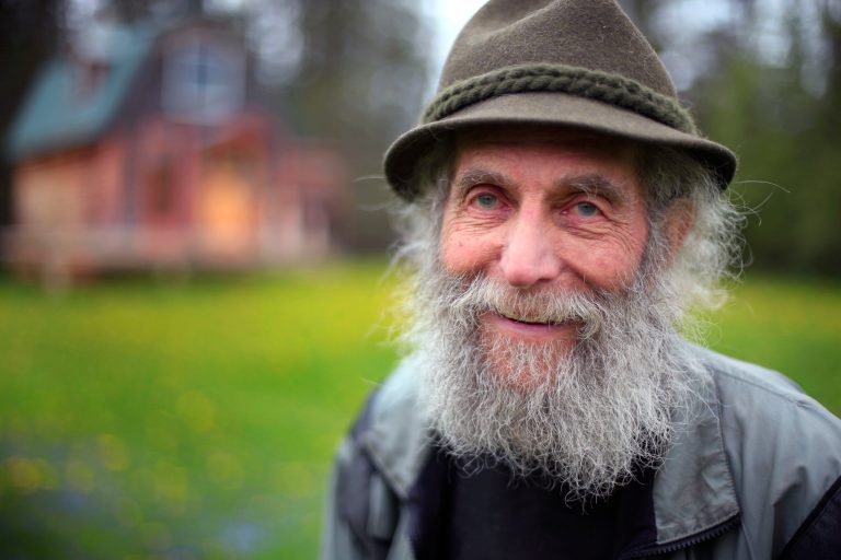 In this photo taken on Friday, May 23, 2014, Burt Shavitz poses on his property in Parkman, Maine. Shavitz, the Burt behind Burt's Bees, still lives in rural Maine after leaving the company that was later sold for millions by his former business partner, Roxanne Quimby. He said he has no regrets, and that he doesn't need much. (AP Photo/Robert F. Bukaty)
