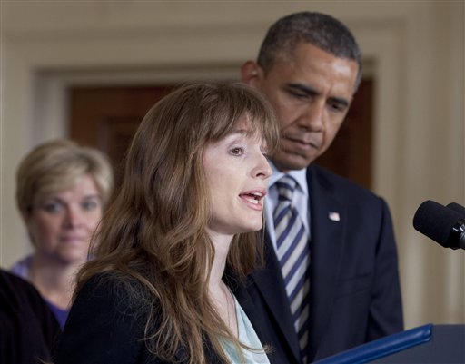 President Barack Obama listens as Katerina Rodgaard, a Maryland dance instructor who knew one of the victims of the Virginia Tech shootings, speaks in the East Room of the White House in Washington, Thursday, March 28, 2013, where the president spoke about measures to protect children from gun violence. (AP Photo/Carolyn Kaster)